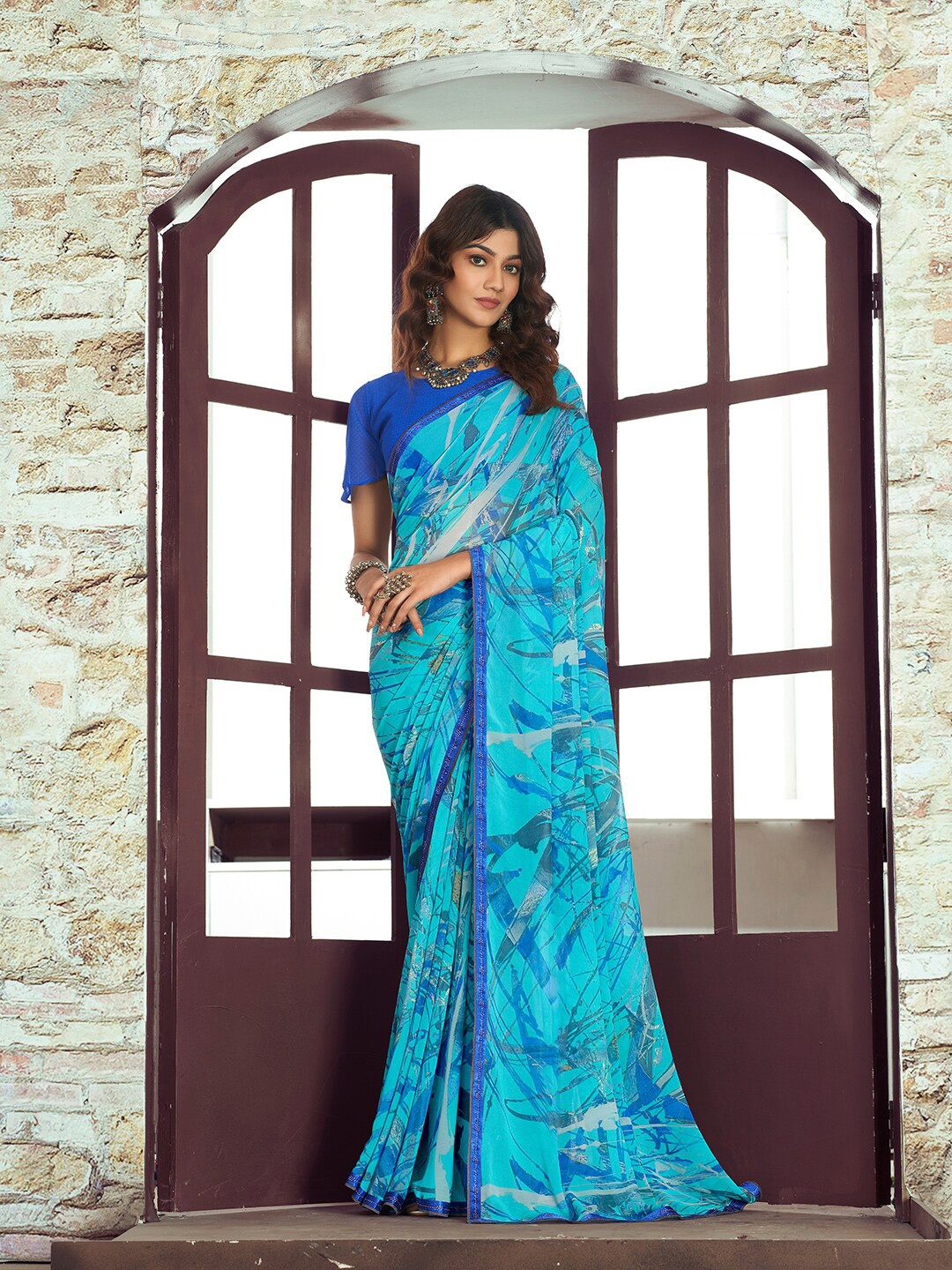 

Shaily Blue & Turquoise Blue Beads and Stones Pure Georgette Saree