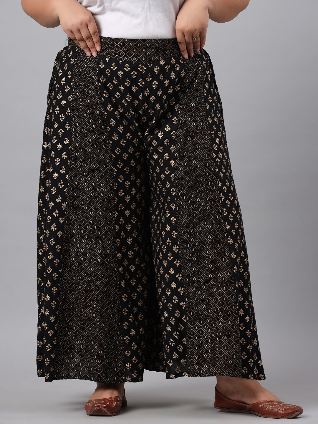 

Juniper Plus Women Black & Gold-Toned Ethnic Motifs Printed Flared Ethnic Palazzos