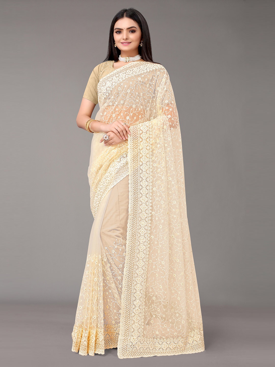 

Nimayaa Beige Colored net Embroidered Saree with matching net Blouse