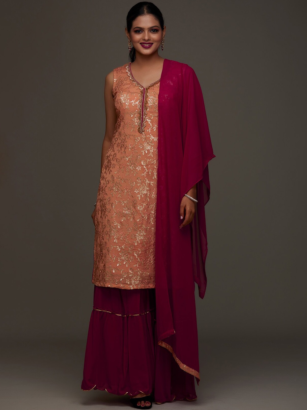 

Koskii Women Peach-Coloured Ethnic Motifs Embroidered Sequinned Kurta with Sharara & With Dupatta