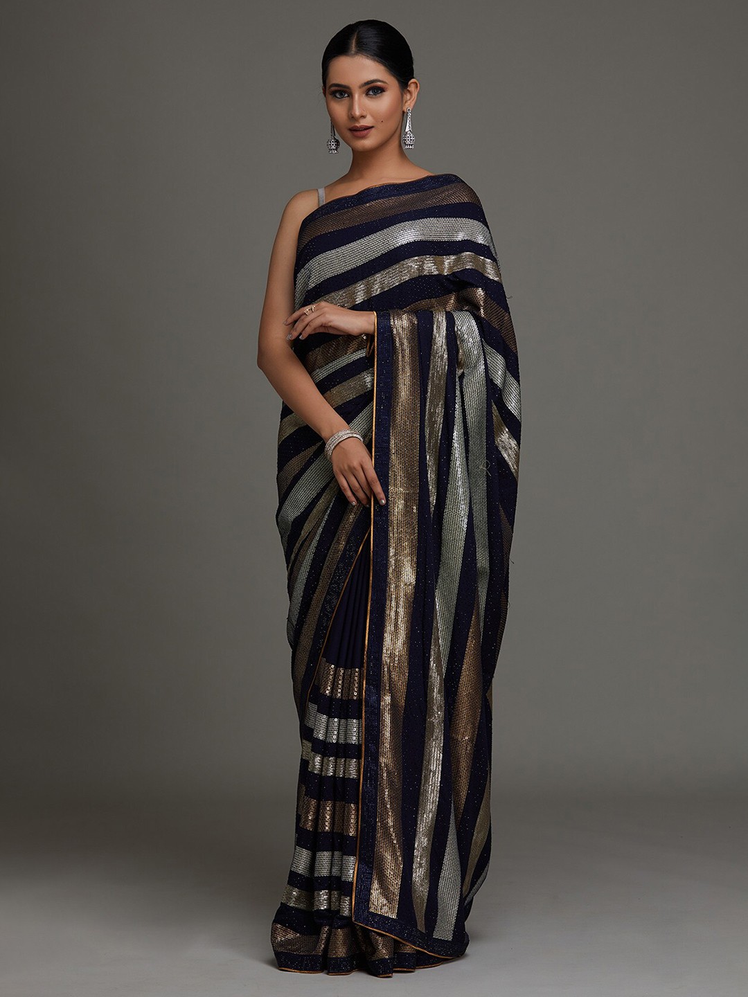 

Koskii Women Navy Blue & Silver-Toned Striped Sequinned Georgette Saree