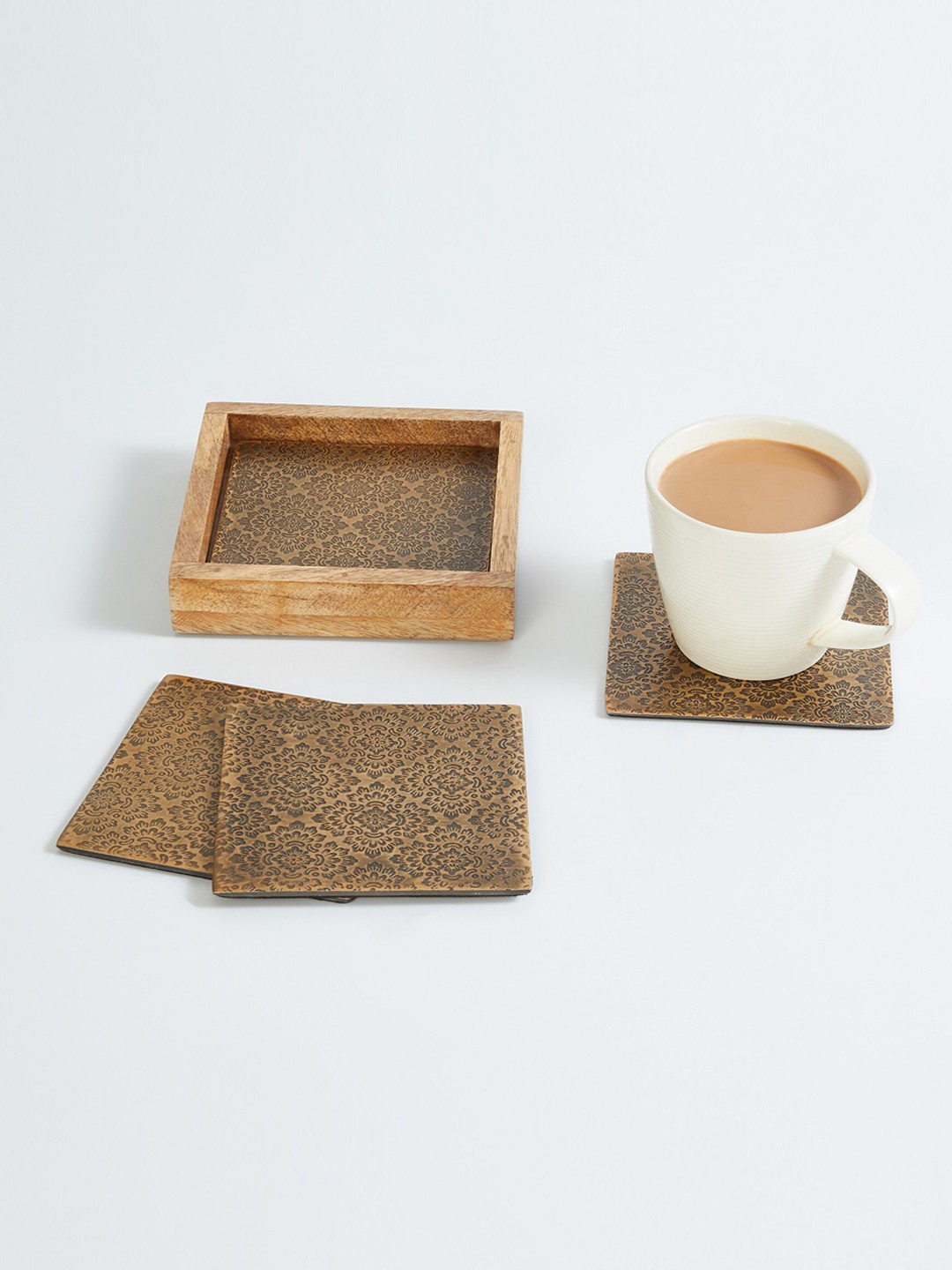 

Home Centre Set Of 4 Gold Coloured Solid Engraved Square Aluminum Coasters With Mango Wood Tray