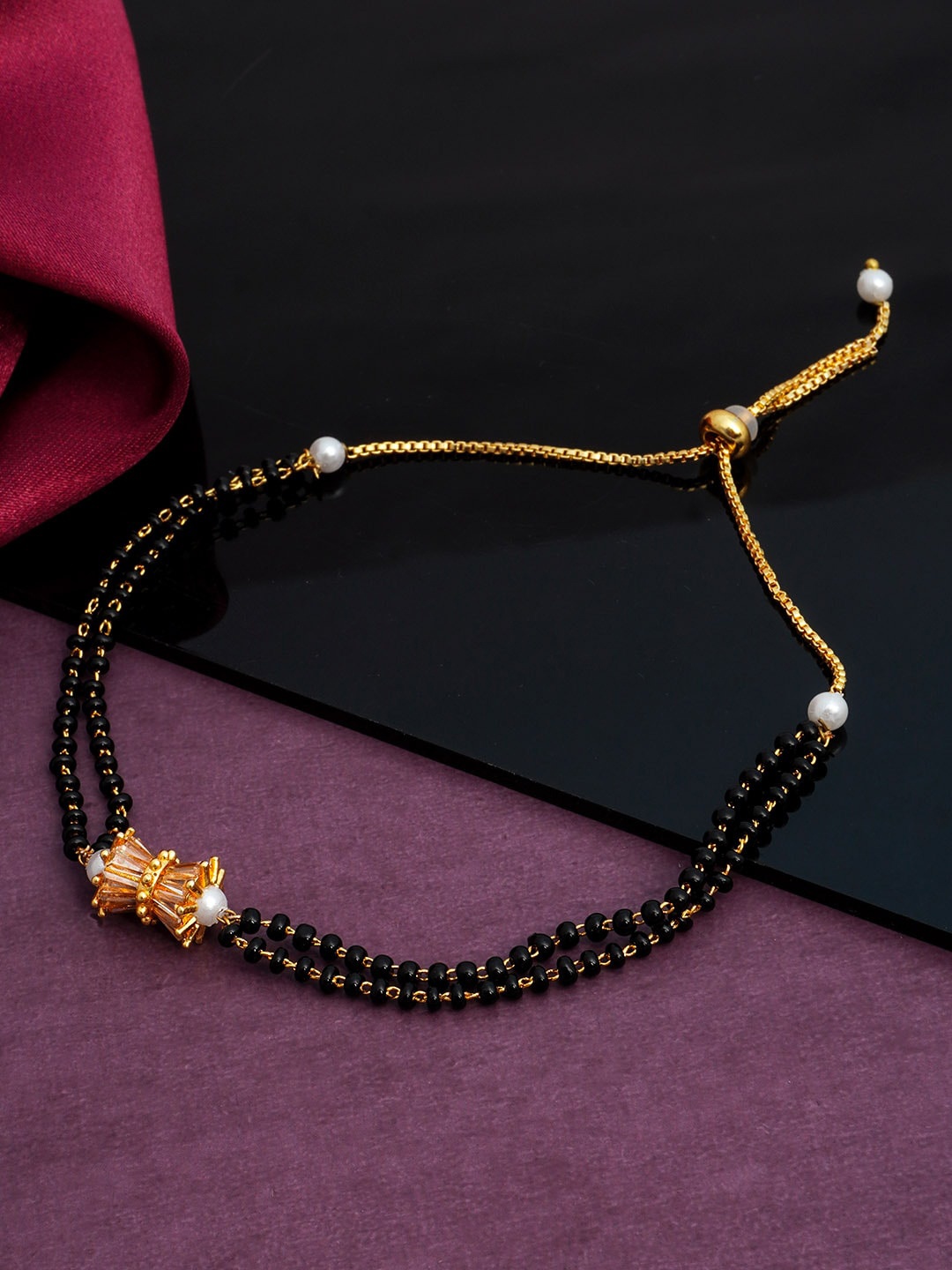 

Urmika Women Gold-Toned & Black Beads Beaded Charm Bracelet
