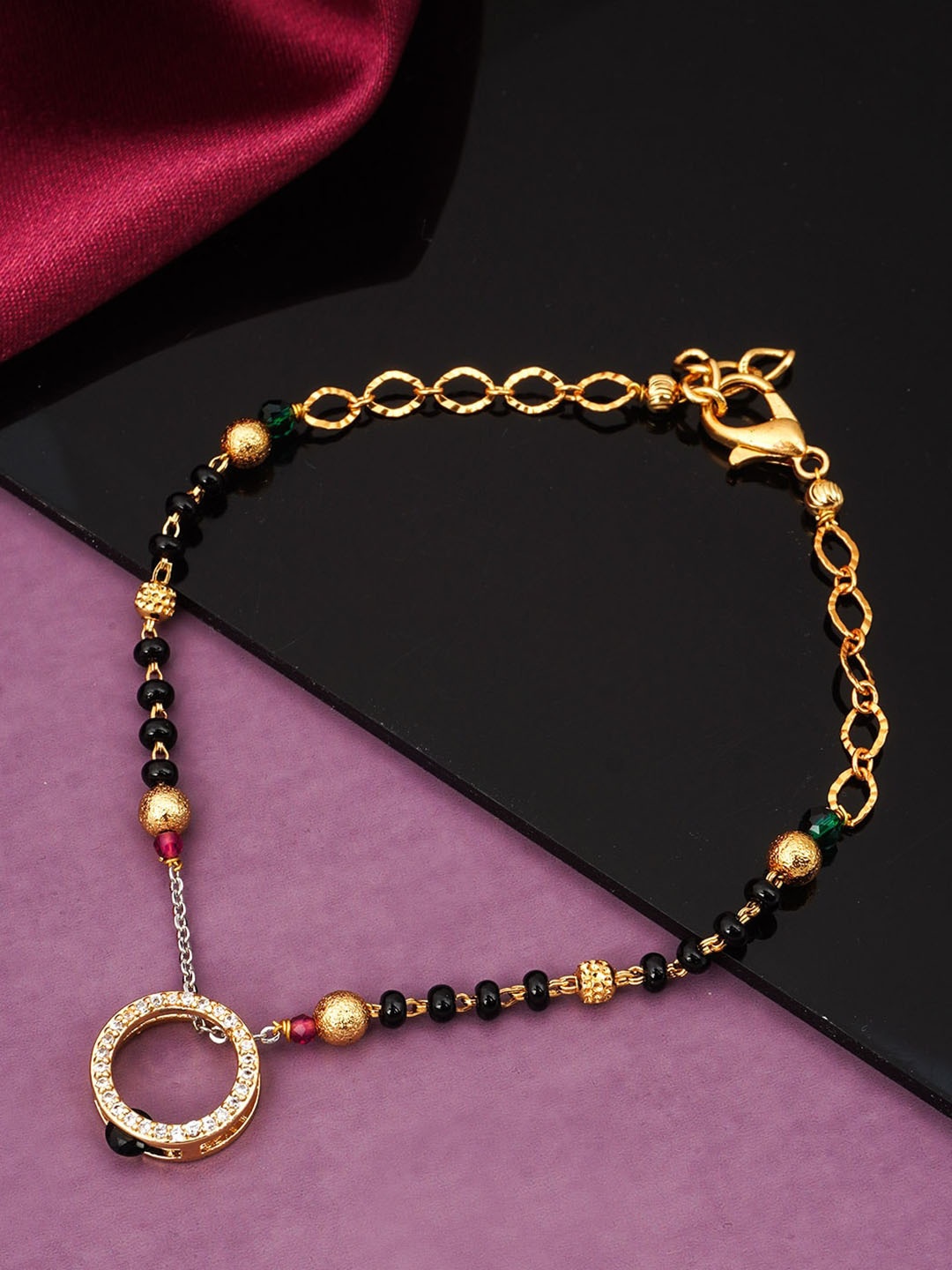 

Urmika Women Gold-Toned & Black Charm Bracelet