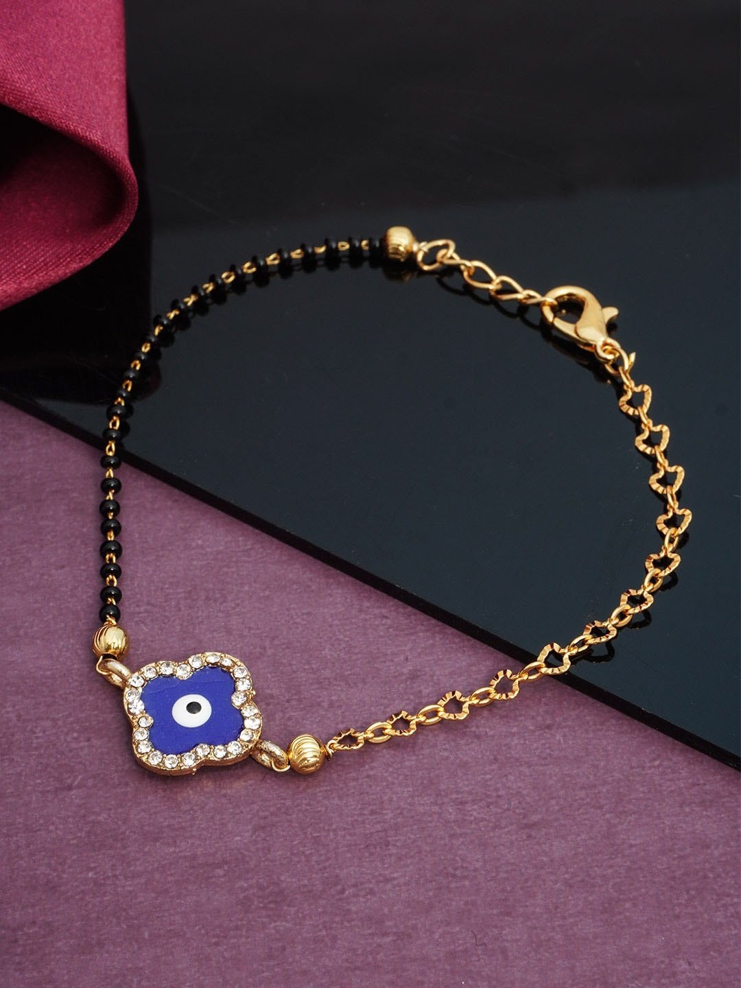 

Urmika Women Gold-Toned & Navy Blue Evil Eye Beaded Bracelet