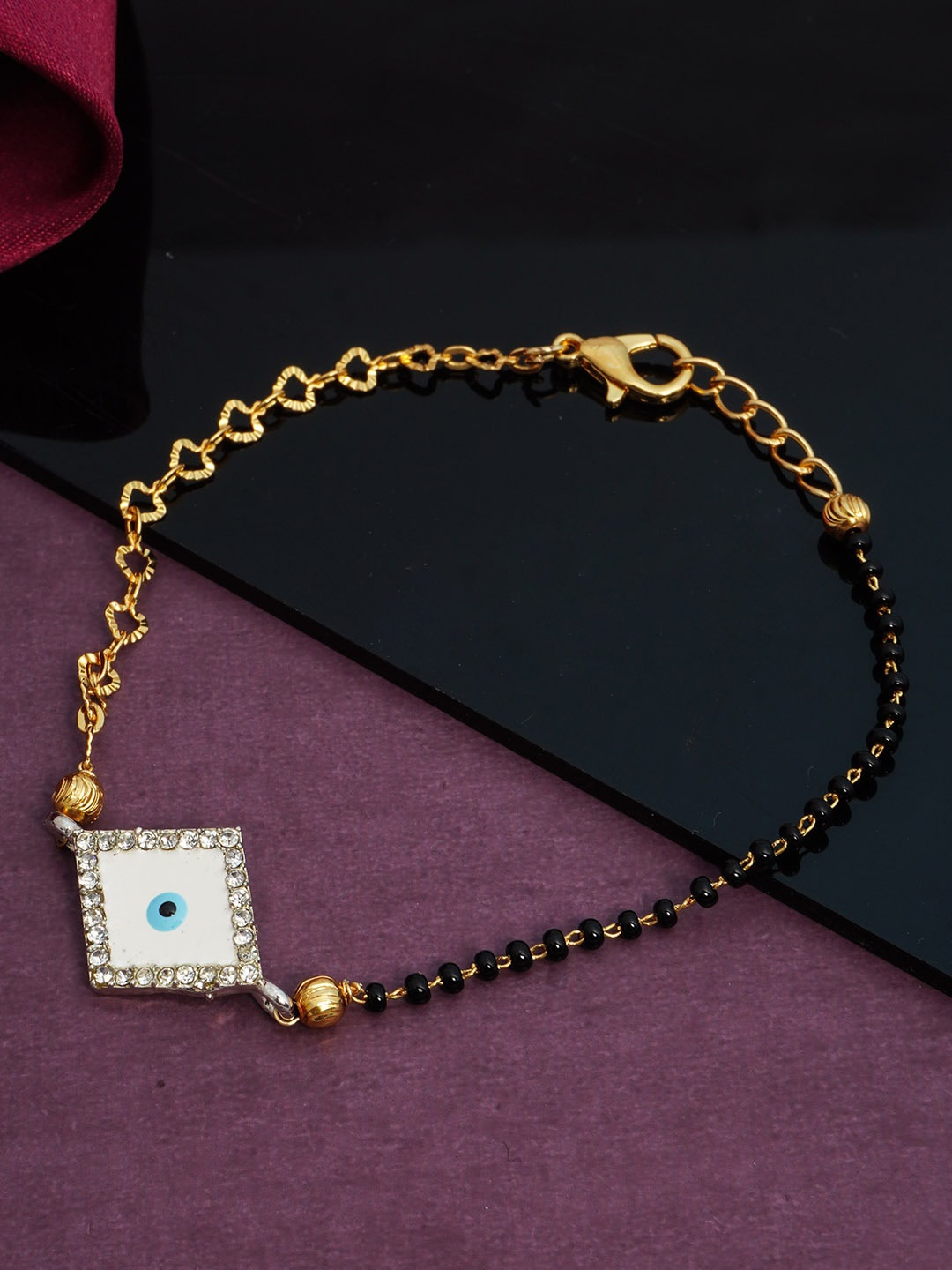 

Urmika Women Gold-Toned & White Evil Eye Beaded Bracelet