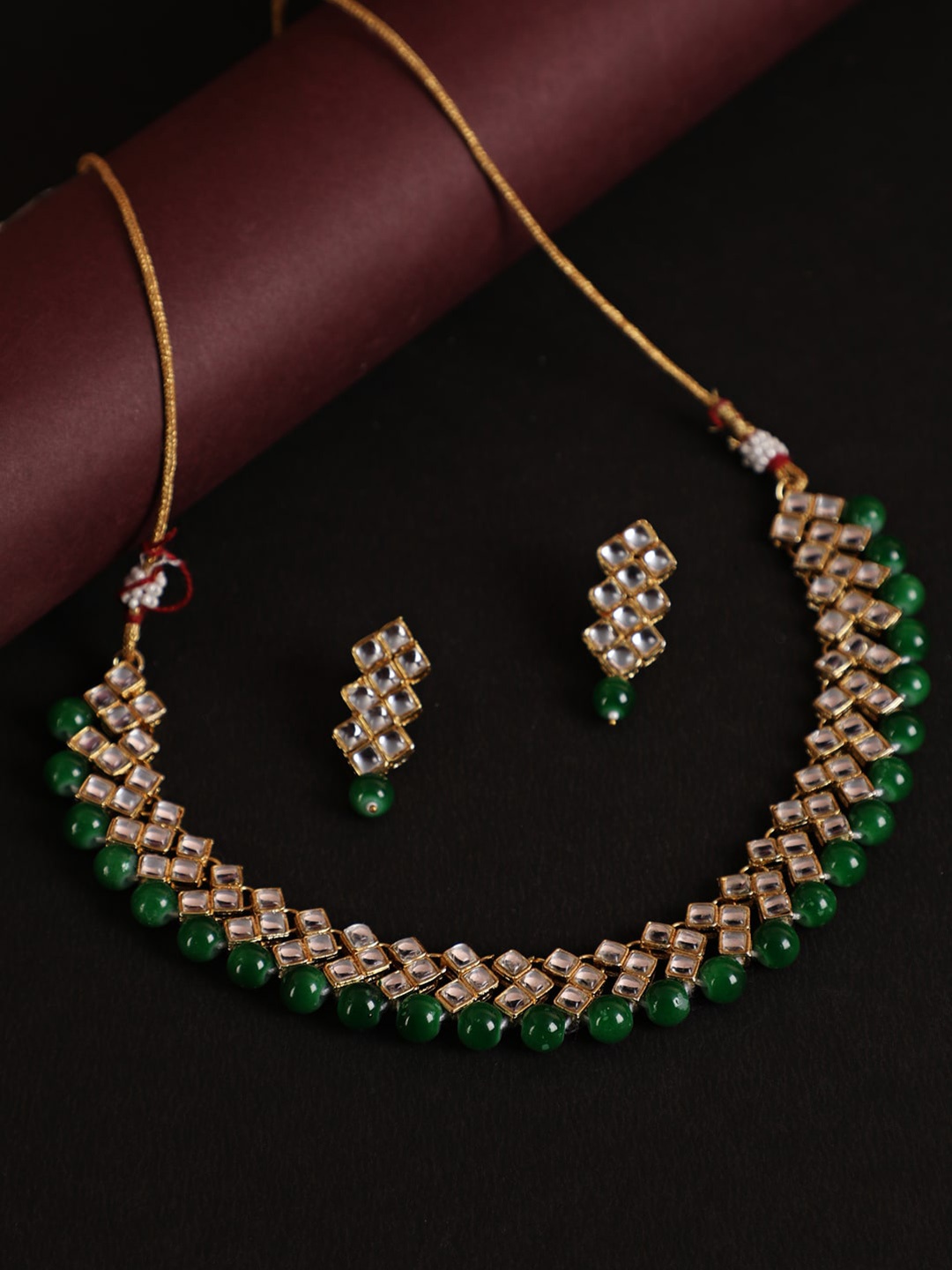 

Jazz and Sizzle Women Gold-Plated Green & White Kundan Studded & Beaded Jewellery Set