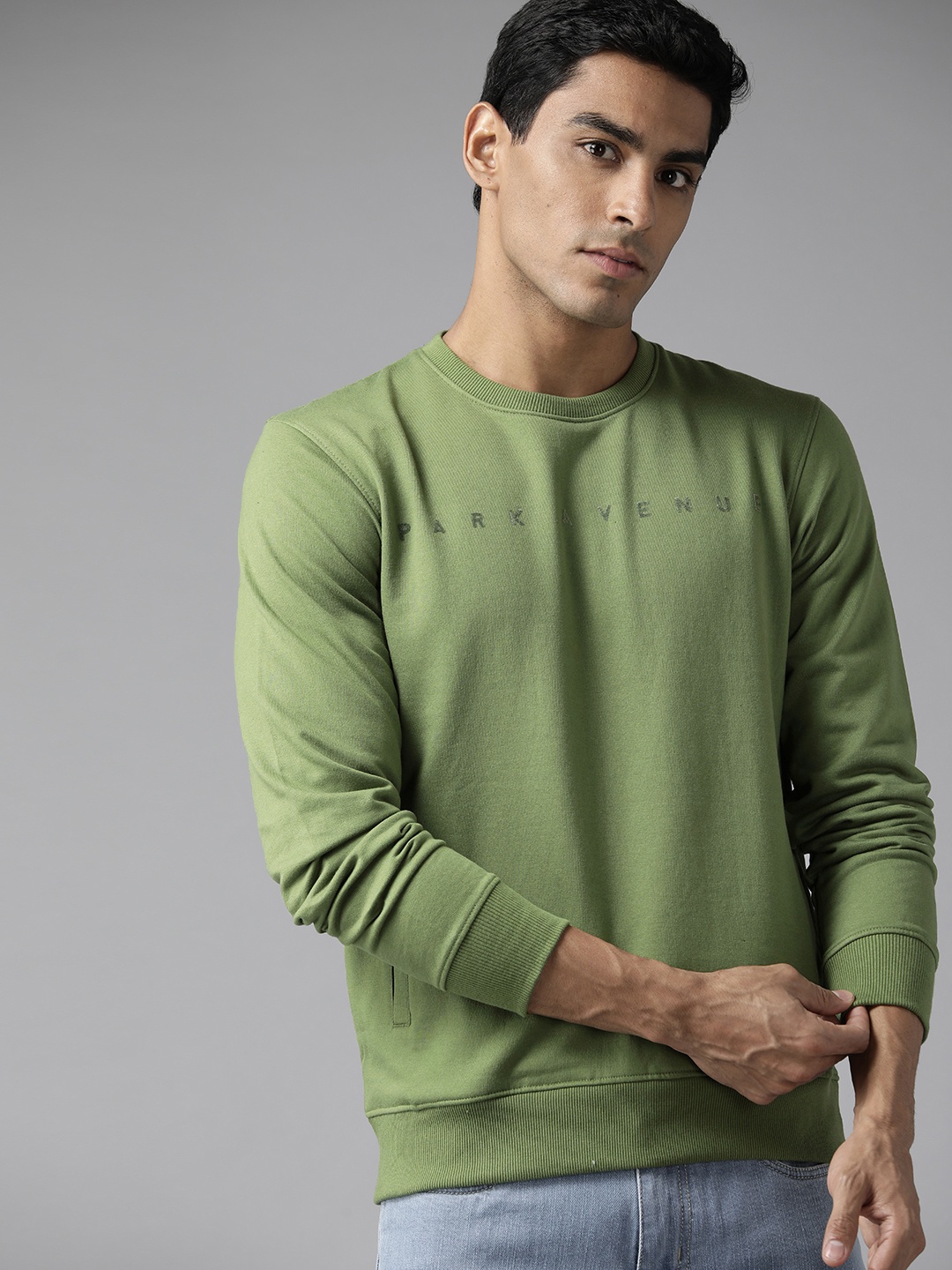 

Park Avenue Men Green Solid Sweatshirt