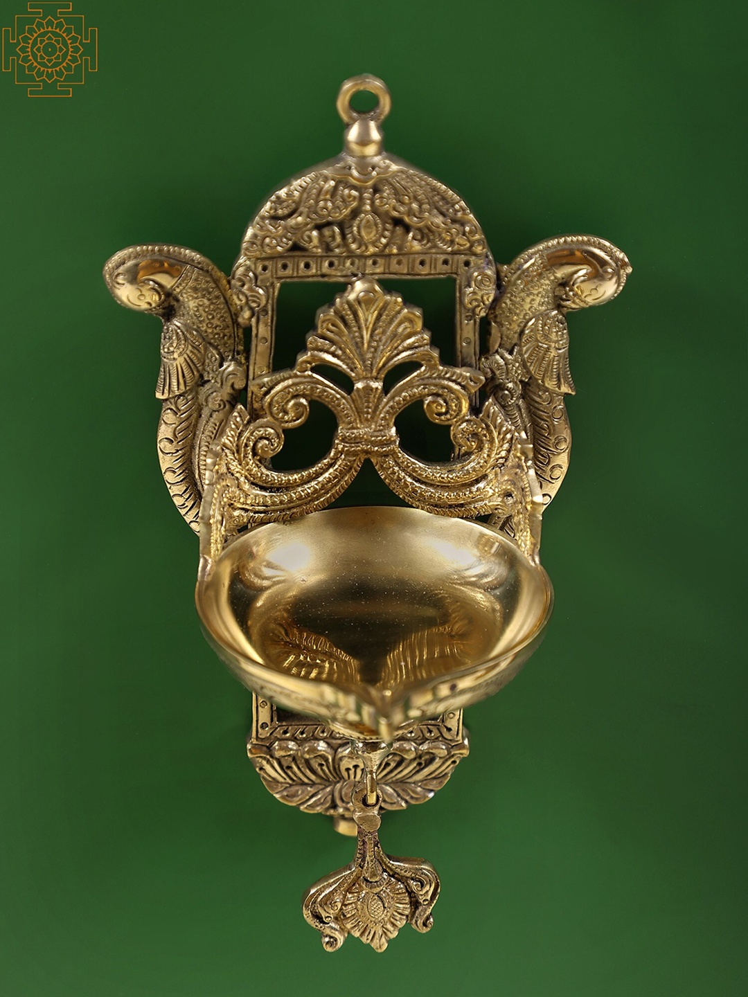 

Exotic India Gold-Toned Peacock Wall Hanging With Diya