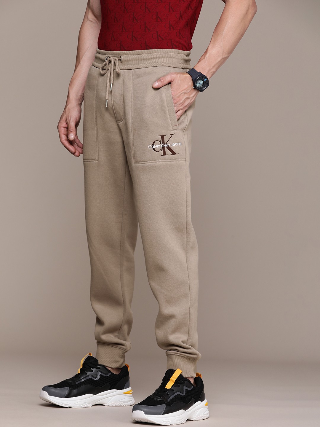 

Calvin Klein Jeans Men Beige Brand Logo Embroidered Joggers