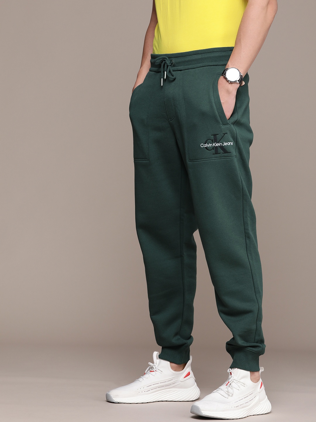 

Calvin Klein Jeans Men Teal Green Brand Logo Printed Mid Rise Pure Cotton Casual Joggers