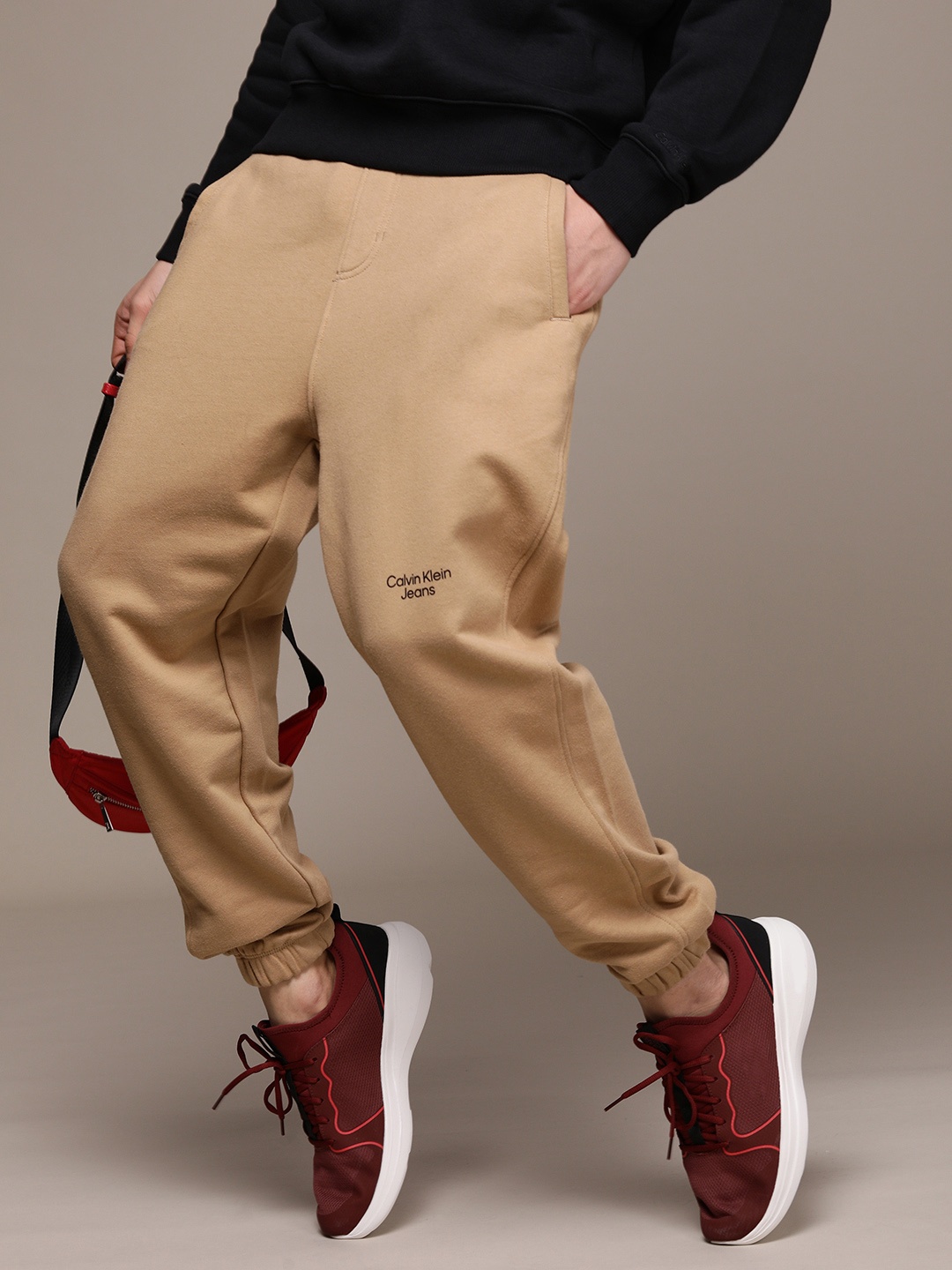 

Calvin Klein Jeans Men Brown Solid Straight Fit Mid Rise Pure Cotton Casual Joggers