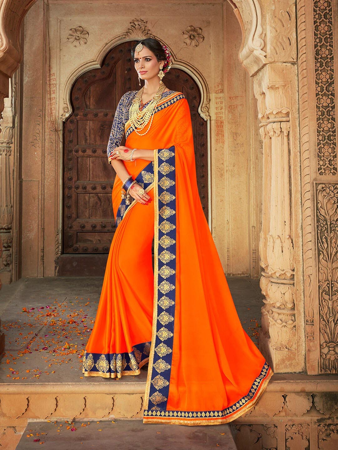 

Shaily Women Orange & Blue Zari Pure Chiffon Saree