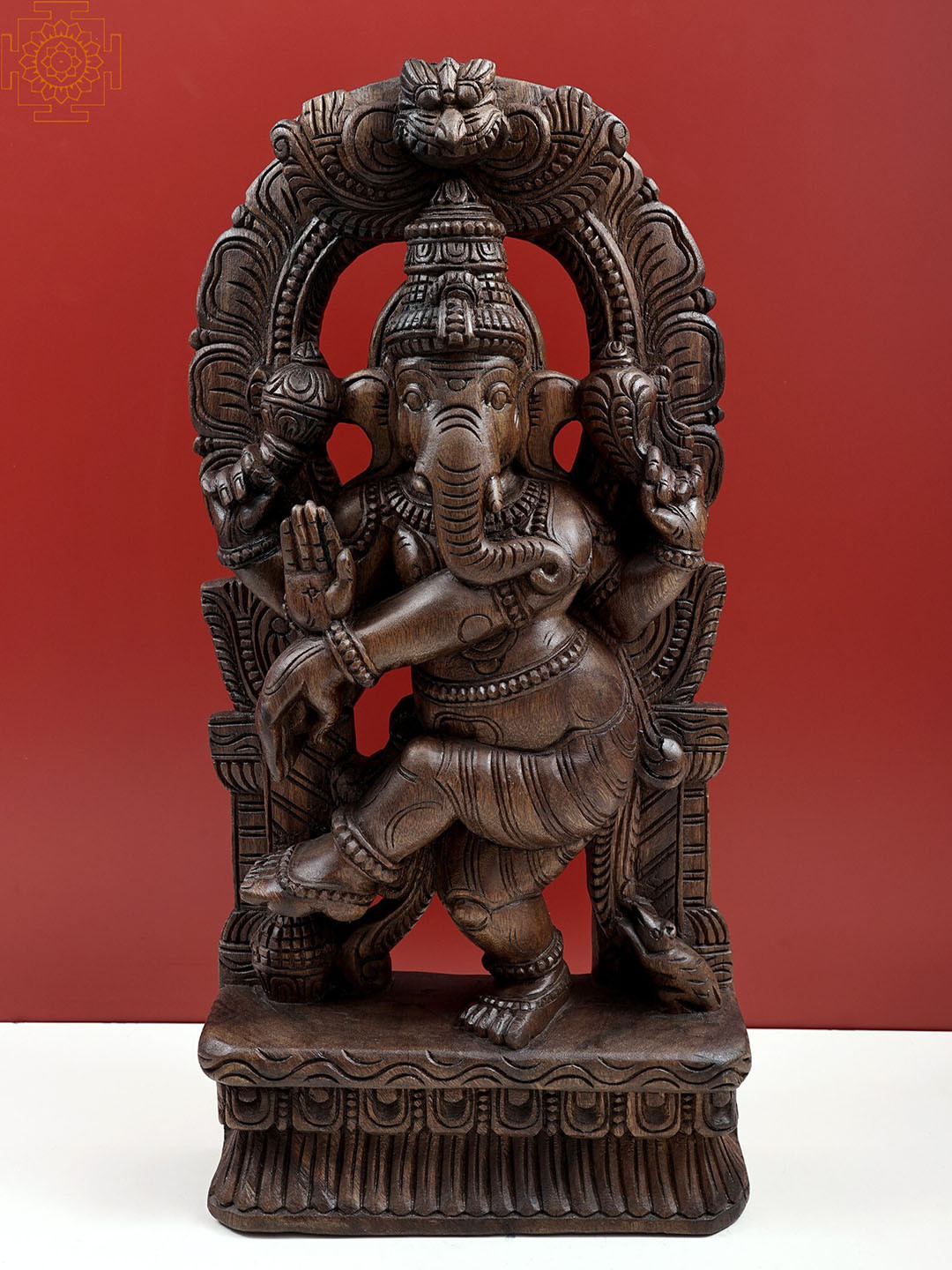 

Exotic India Brown Wooden Dancing Ganesha with Kirtimukha Prabhavali Wall Hanging