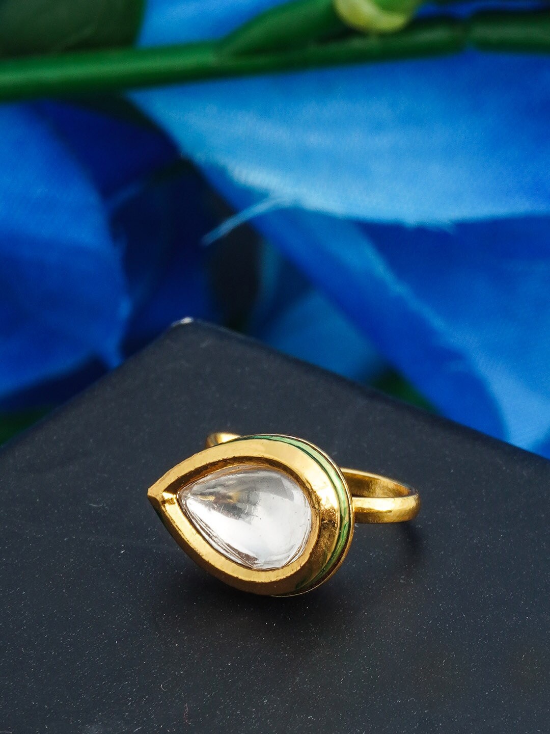 

Urmika Women Gold-Toned & White Crystal Studded Almond Shaped Nose Pin