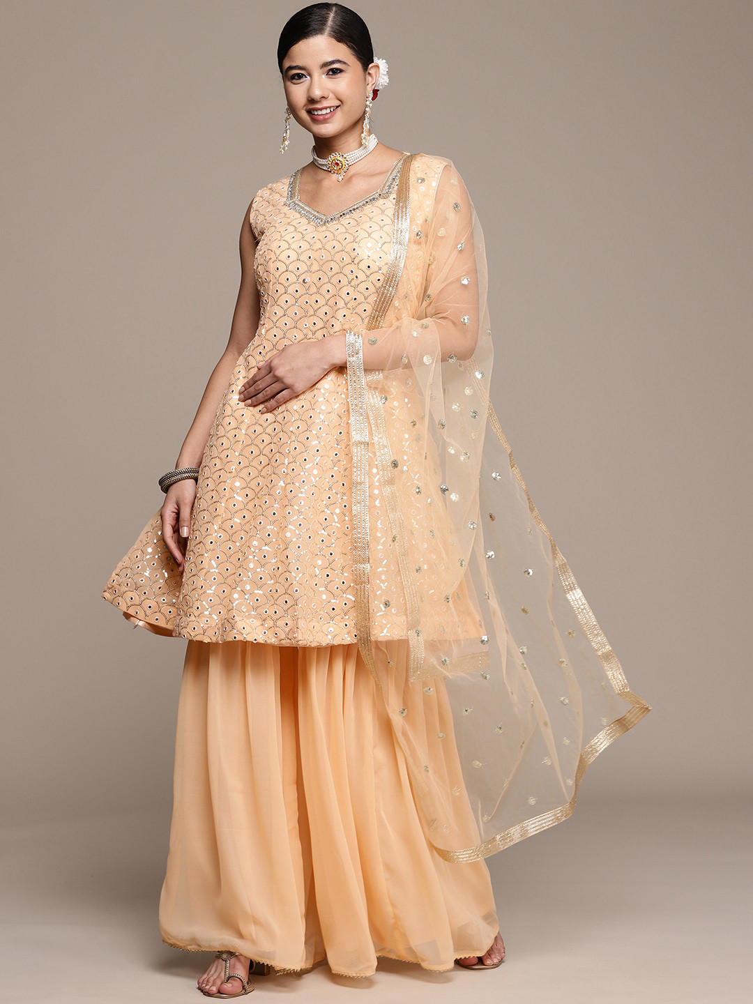 

SAARYA Women Peach-Coloured Ethnic Motifs Embroidered Panelled Sequinned Kurta with Sharara & With Dupatta