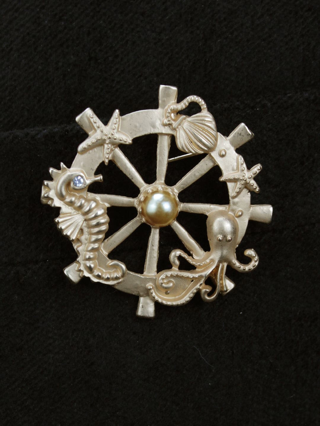 

Kavove Copper-Toned & White Stone Studded The Ocean Wheel Brooch