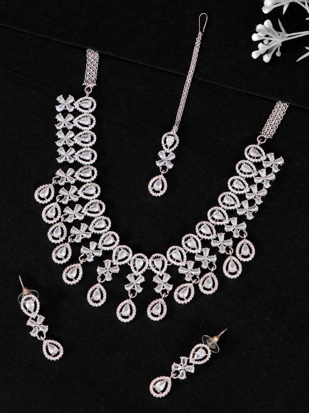 

SwaDev Women Silver-Plated White AD-Studded & Beaded Jewellery Set With Maang Tika