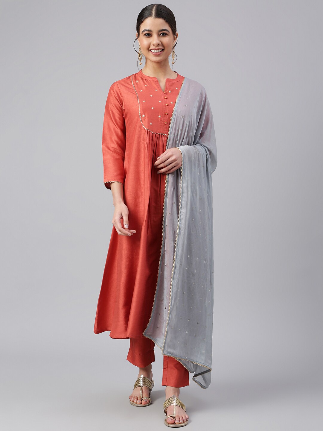 

Janasya Women Rust Dola Silk Solid Kurta with Trousers and Dupatta