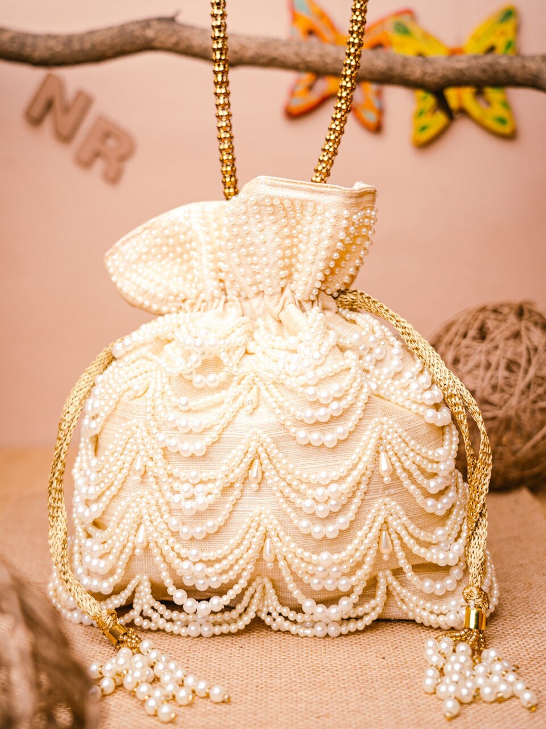 

NR By Nidhi Rathi Cream-Coloured & Yellow Embroidered Potli Clutch