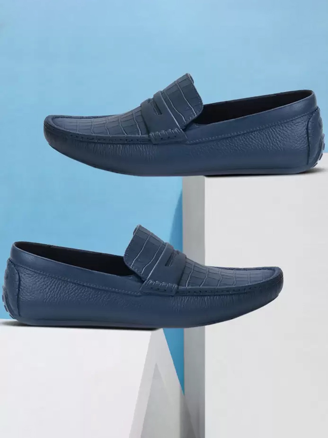 

Ajanta Men Blue Textured Slip On Loafers