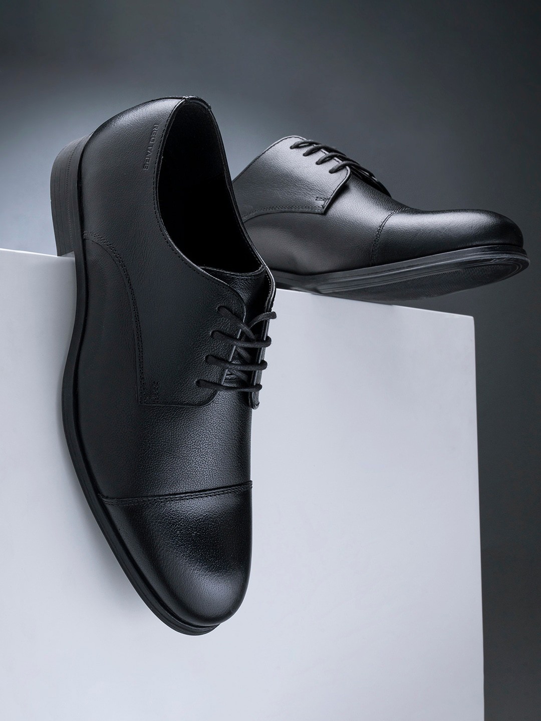 

Red Tape Men Black Solid Leather Derbys