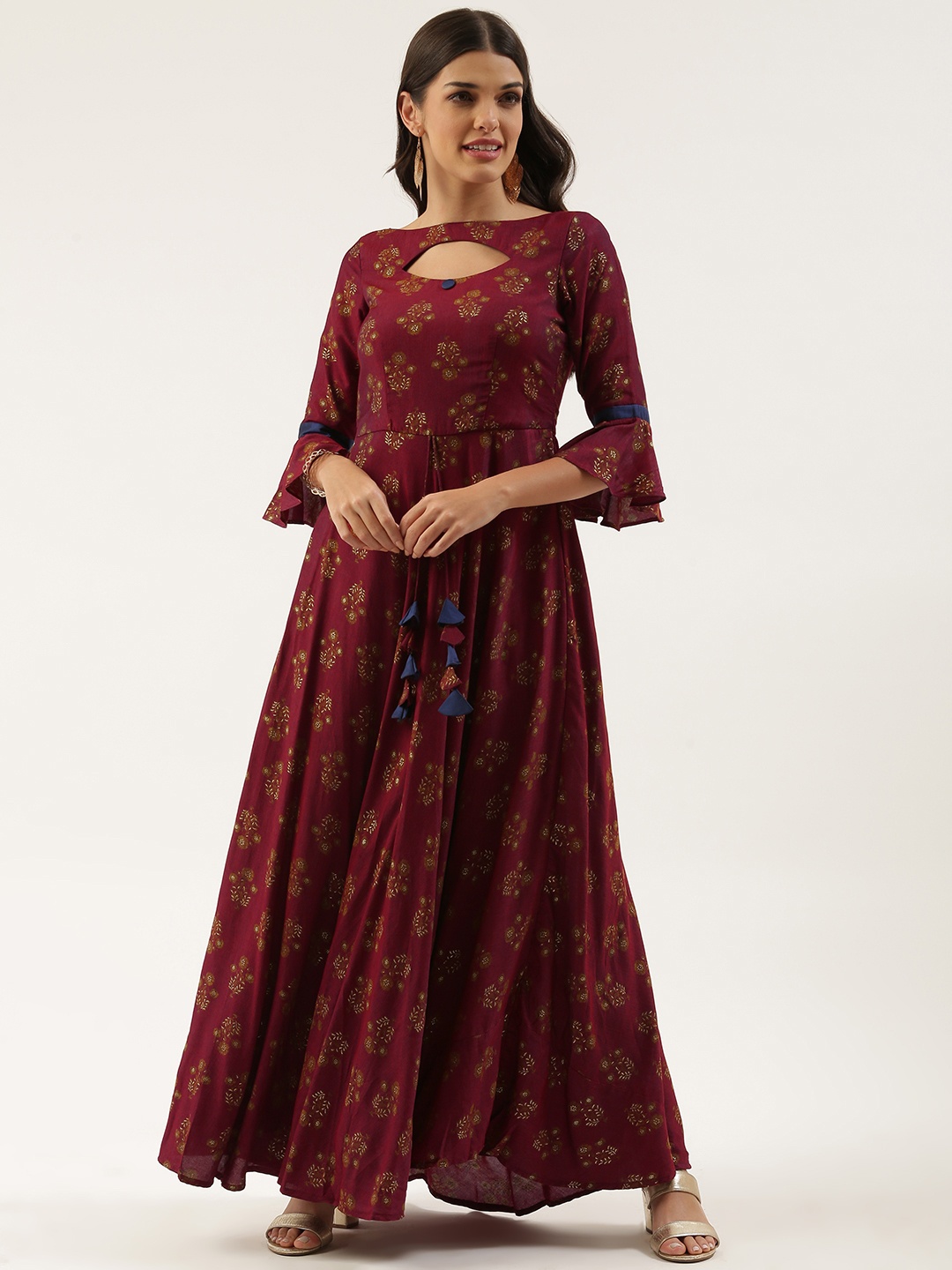 

Ethnovog Maroon Gold Floral Maxi Ethnic Dress Cut-Out with Tassels