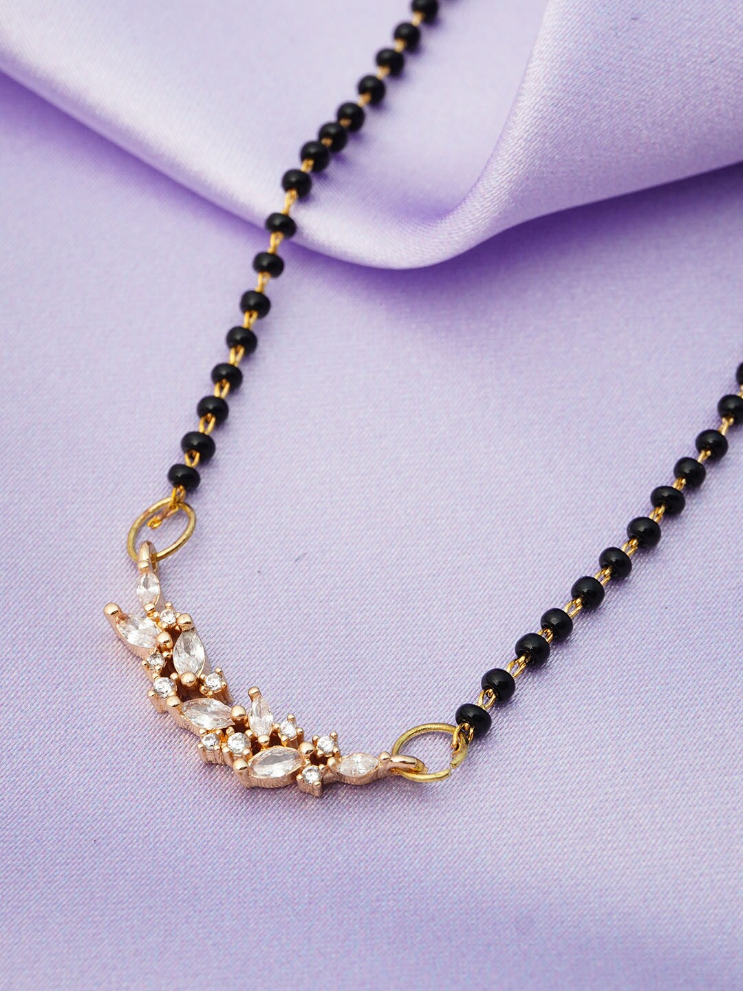 

Ferosh Black & Gold Toned Gold Plated Leaf Pendant Stone-Studded Beaded Mangalsutra