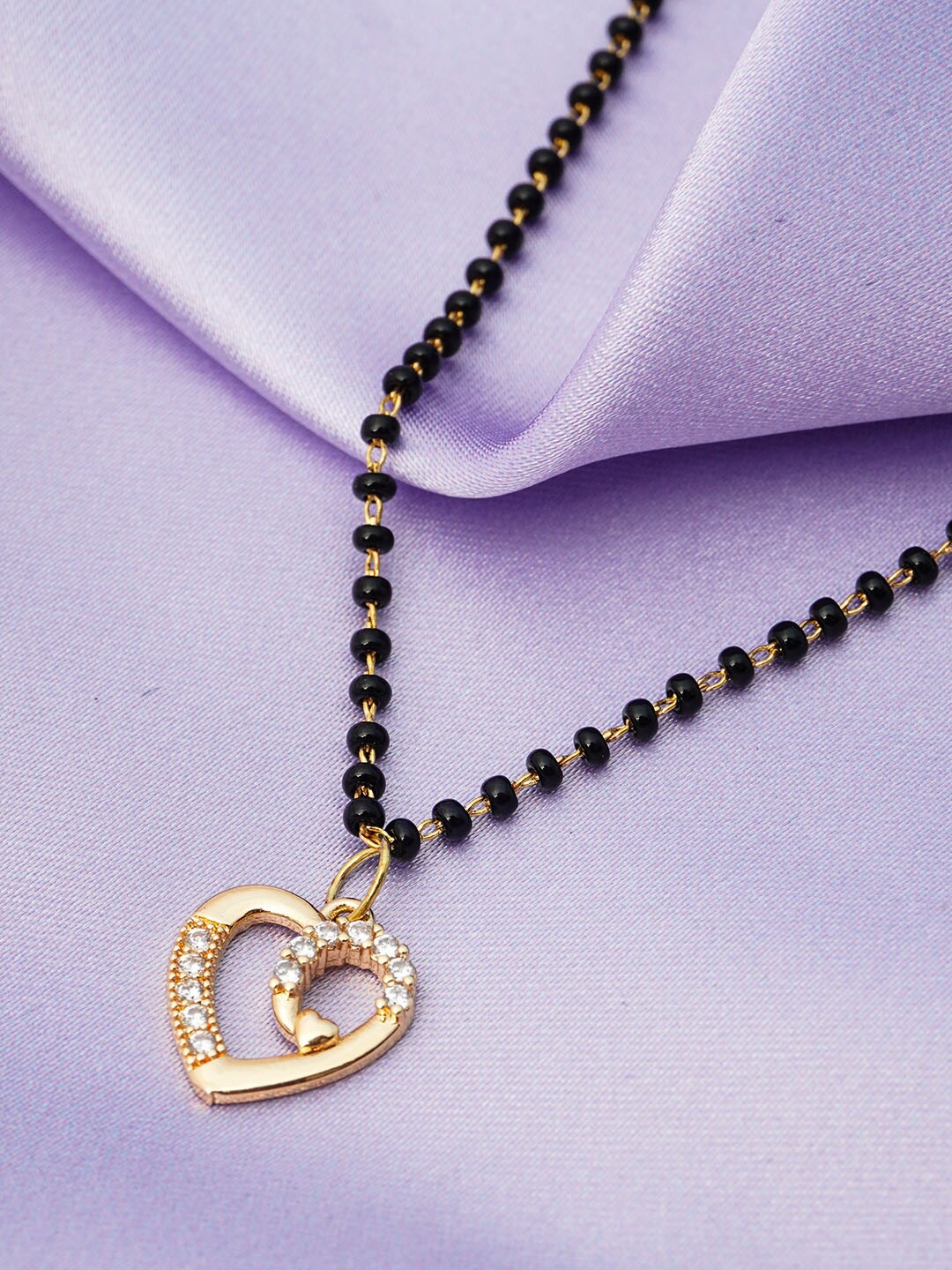 

Ferosh Black And Gold Toned Gold-Plated Crystal Heart Pendant Beaded Mangalsutra