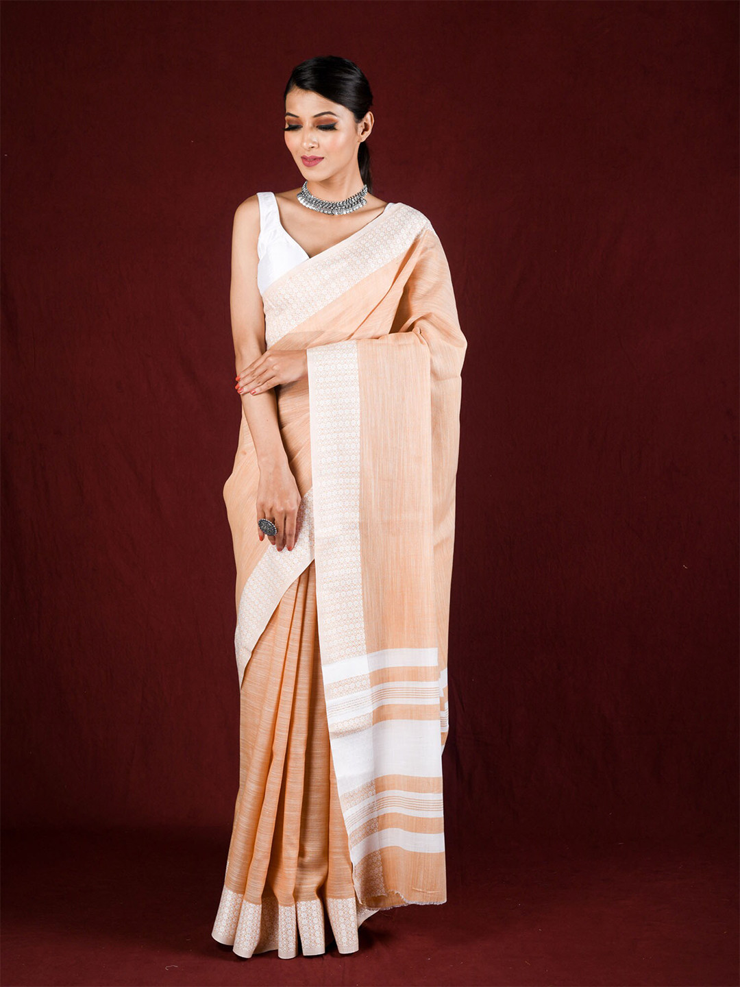 

Exclusiva Orange & White Embroidered Border Saree