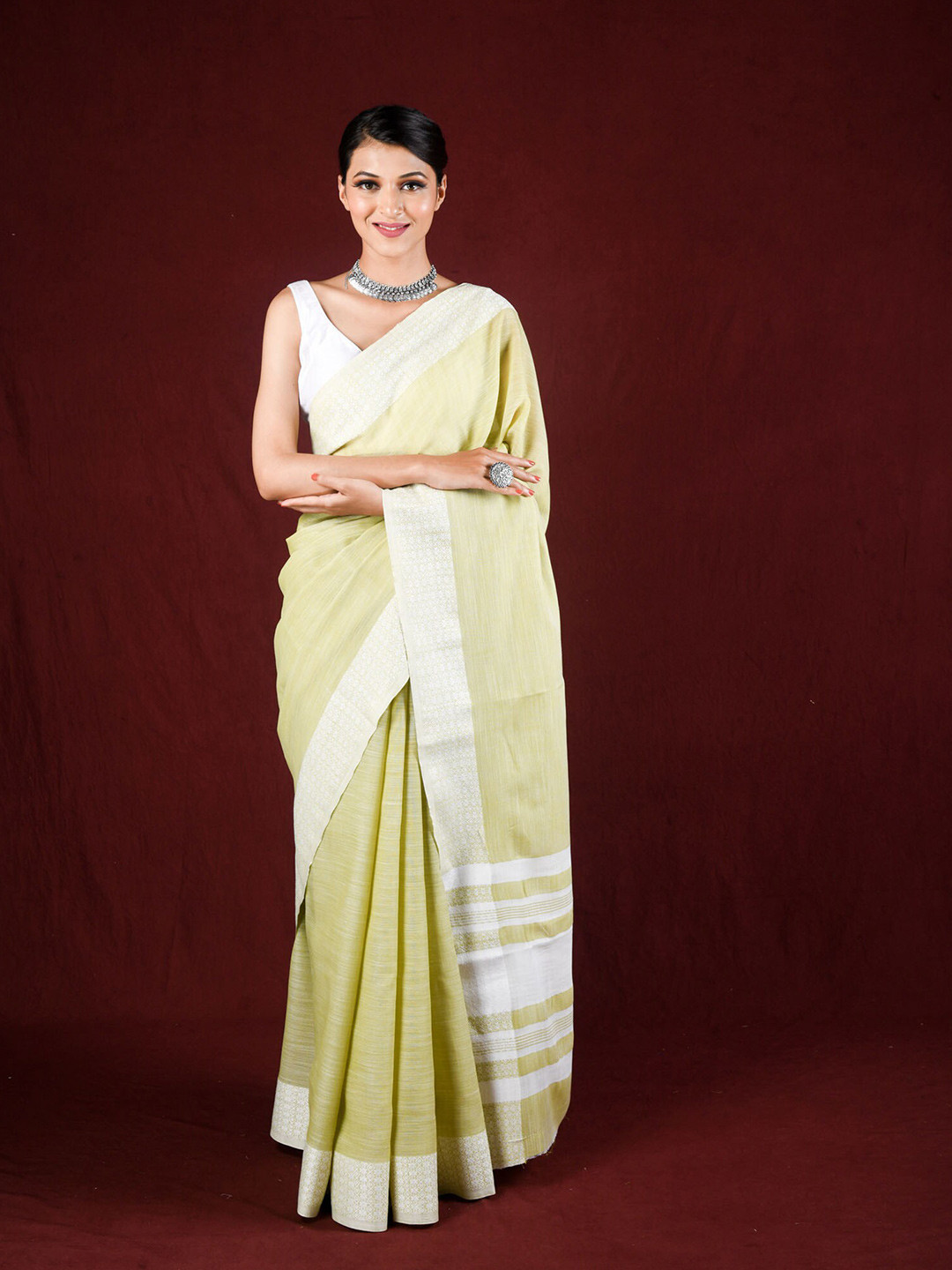 

Exclusiva Green & White Embroidered Border Saree