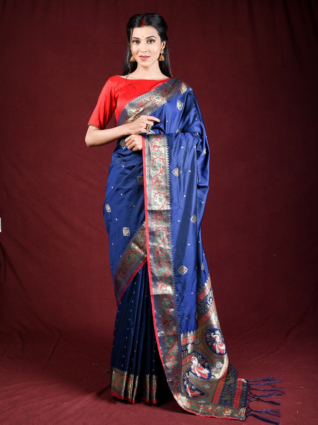 

Exclusiva Blue & Red Ethnic Motifs Zari Silk Blend Saree