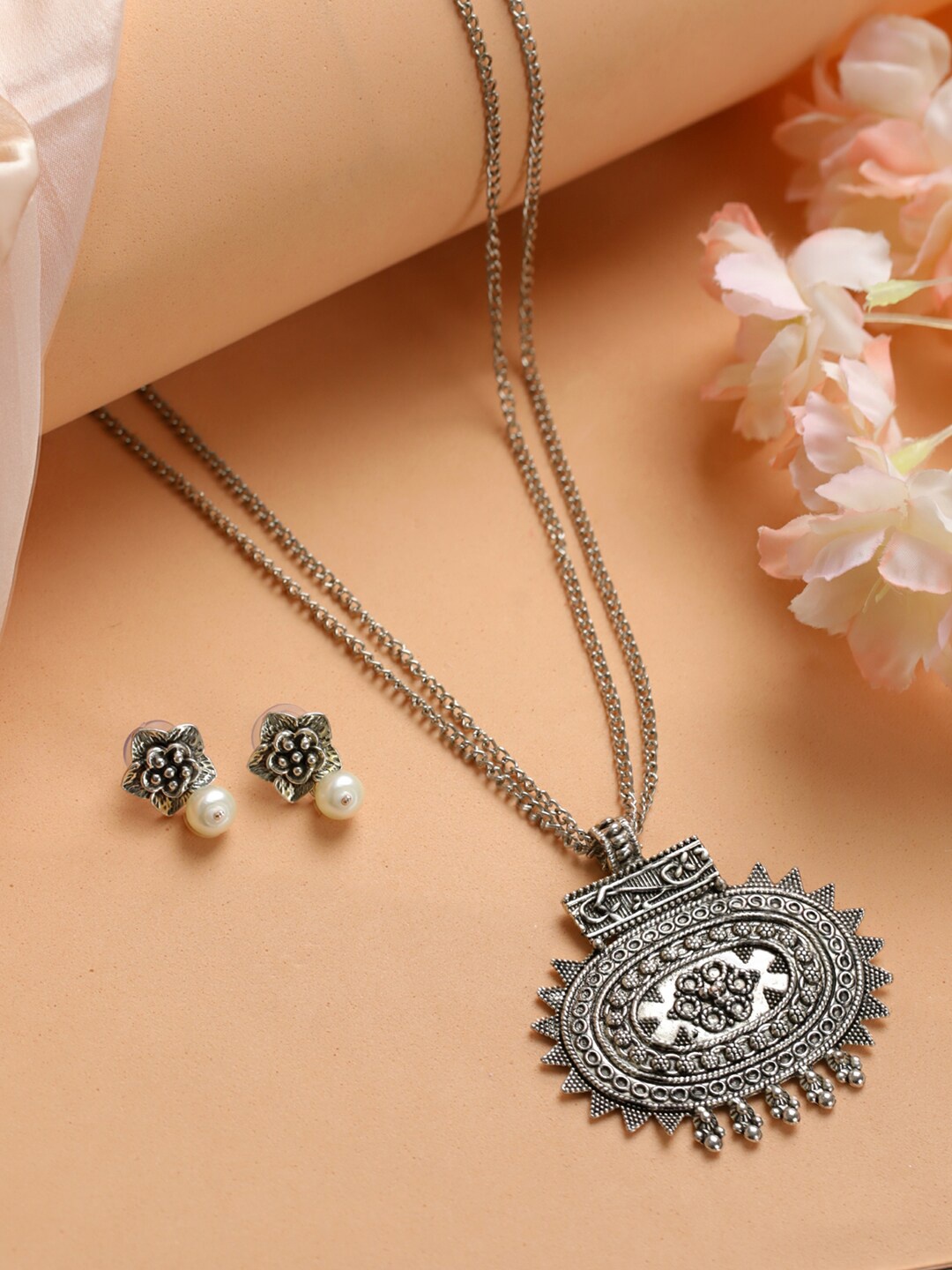 

Jazz and Sizzle Silver Toned and Plated Pearl Studded Oxidised German Silver Jewellery Set