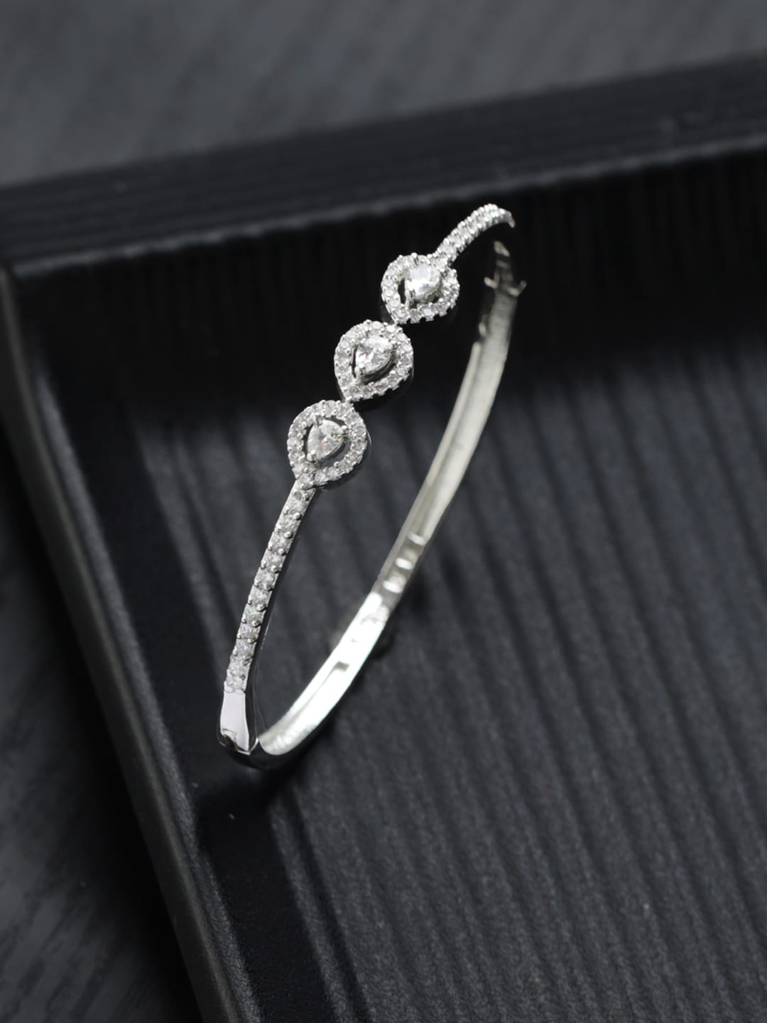 

Priyaasi Women Brass American Diamond Silver-Plated Bangle-Style Bracelet