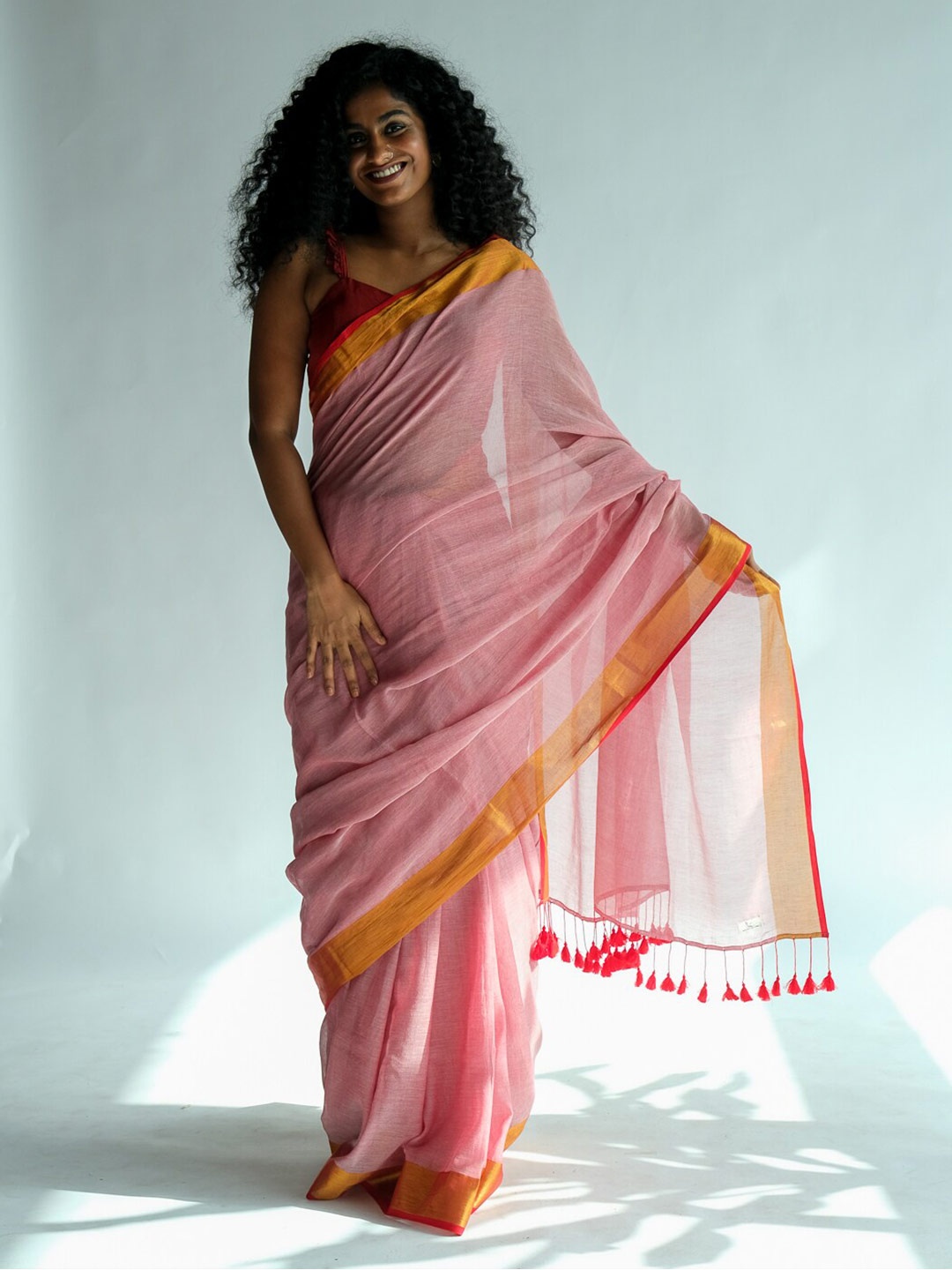 

Suta Peach-Coloured & Red Solid Zari Saree