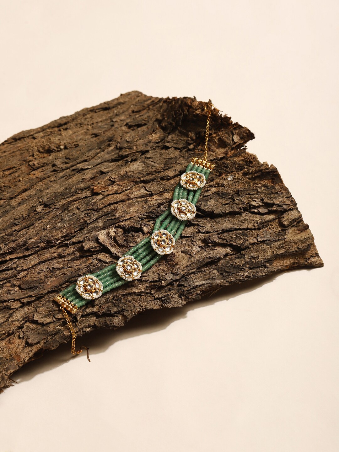 

Ruby Raang Gold-Plated Green Kundan Studded Headband