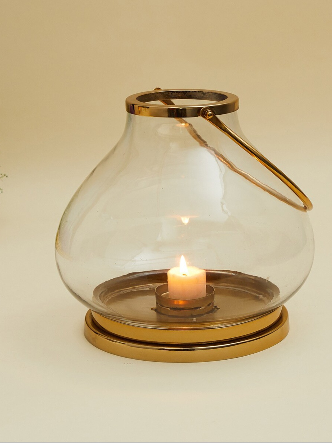 

Home Centre Transparent & Gold-Toned Glass T-Light Holder Lantern With Metal Base
