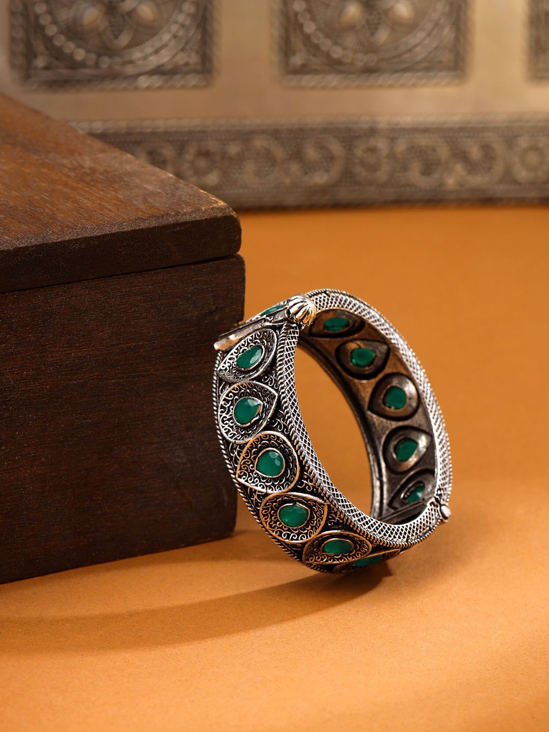 

Yellow Chimes Green Stone Studded Leaf Designed Silver Oxidised Bangle