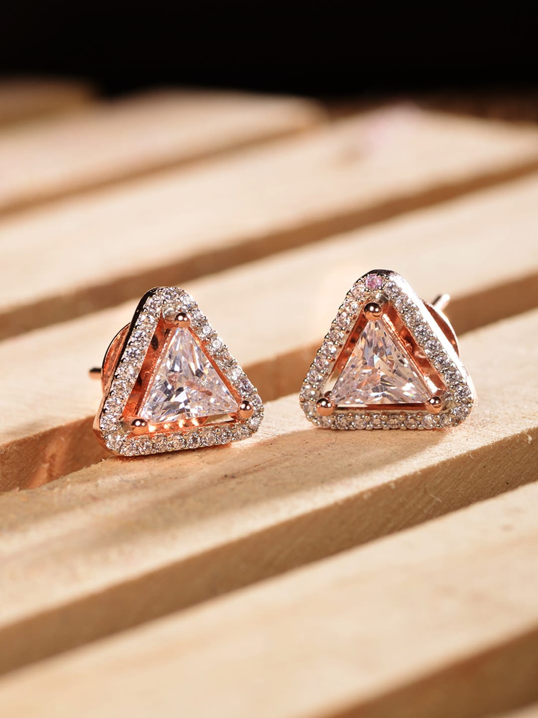 

Saraf RS Jewellery Rose Gold Plated White AD Studded Triangular Studs Earrings