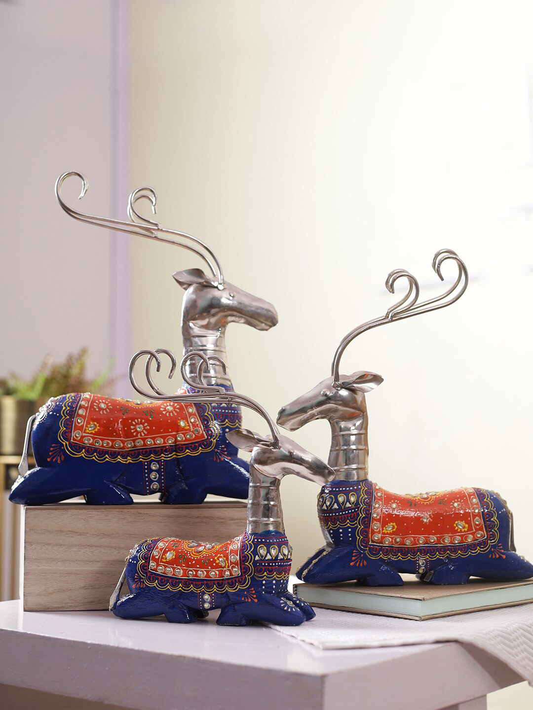 

Aapno Rajasthan Set of 3 Blue & Orange Reindeer Showpieces