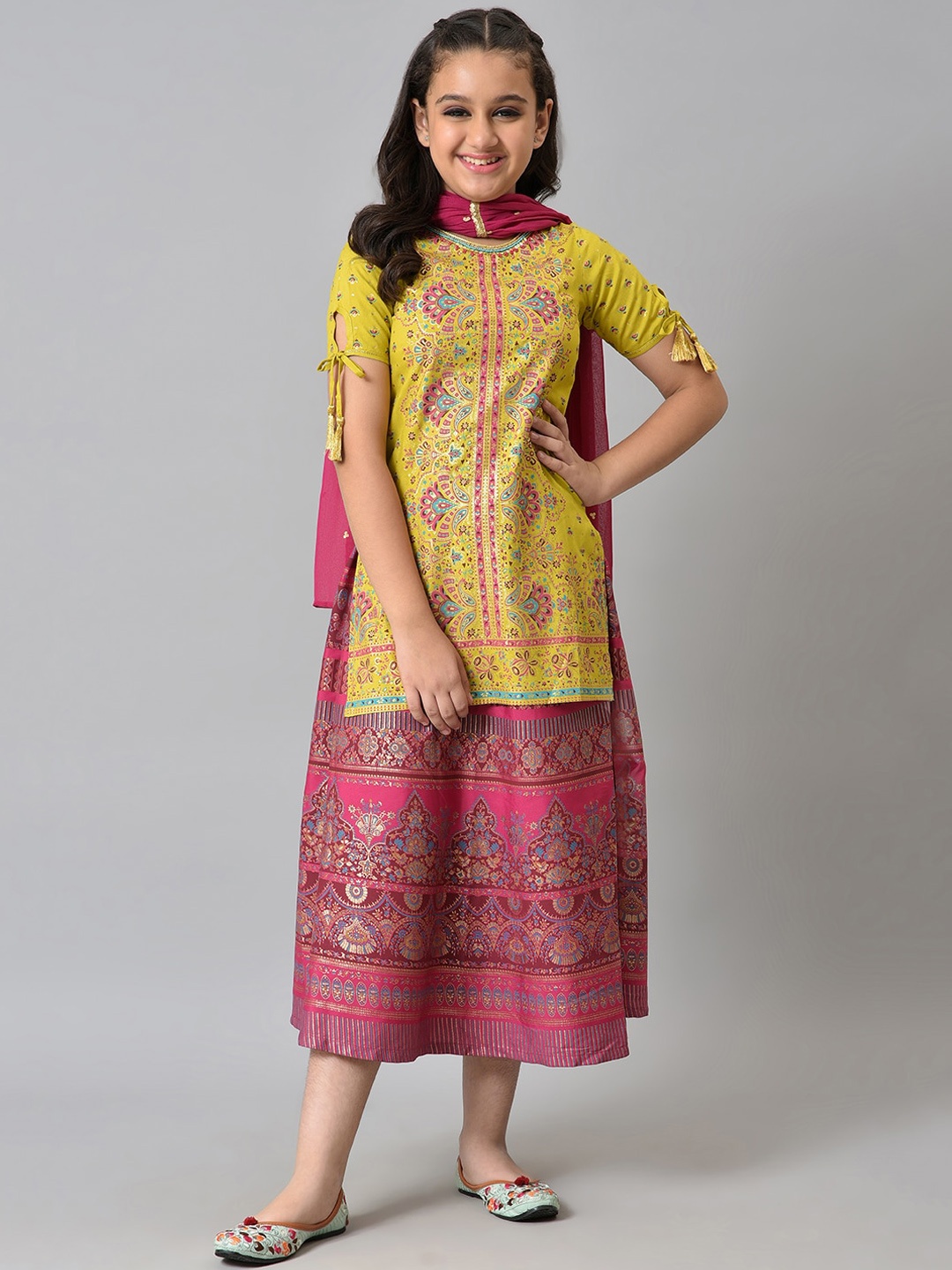 

Aurelia Girls Green Printed Liva Kurta With Pink Skirt And Dupatta