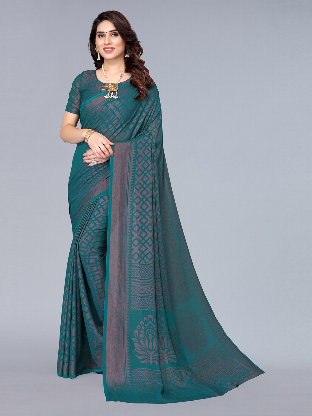 

Winza Designer Teal Green And Gold Toned Geometric Print Zari Pure Chiffon Saree