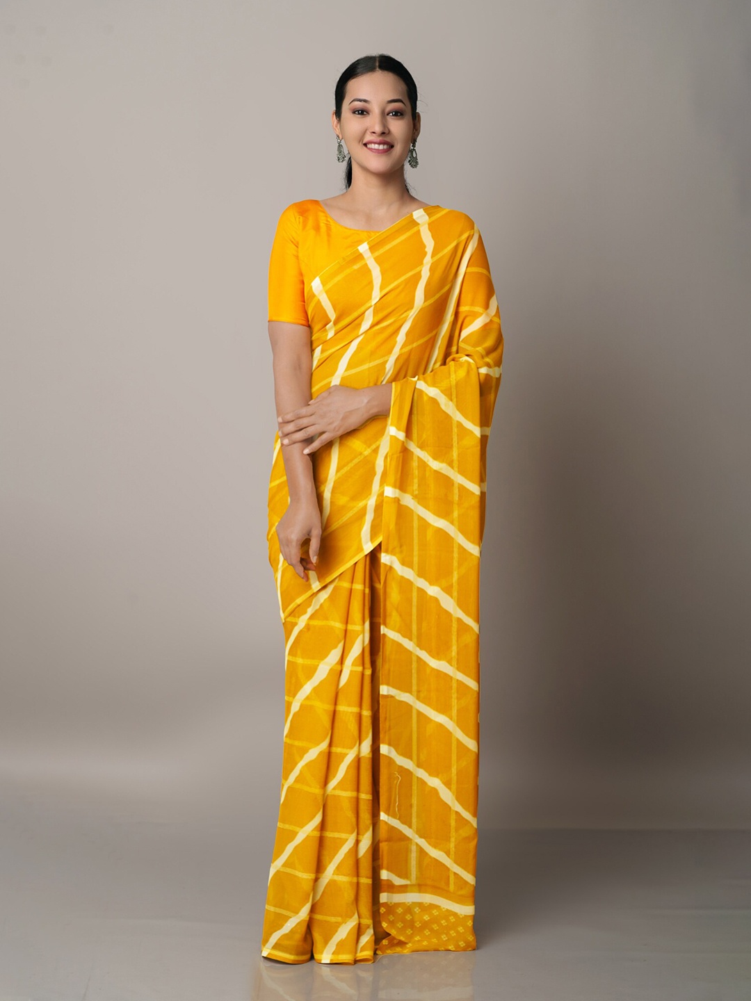 

Unnati Silks Orange & White Leheriya Georgette Block Printed Saree