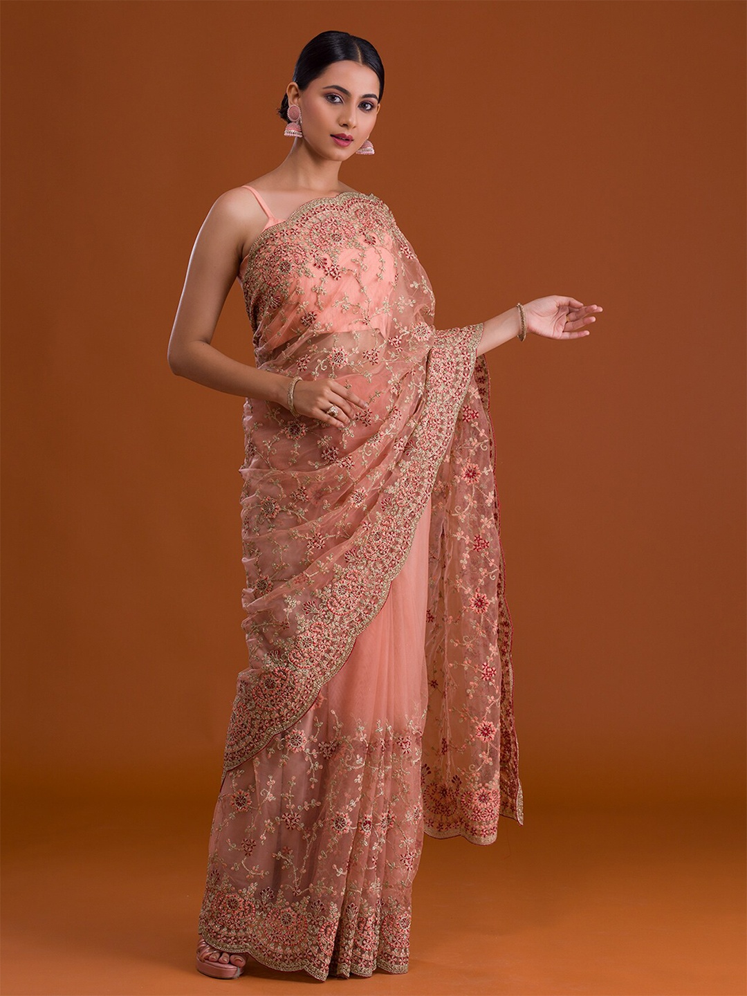 

Koskii Peach-Coloured & Red Floral Zari Net Heavy Work Saree