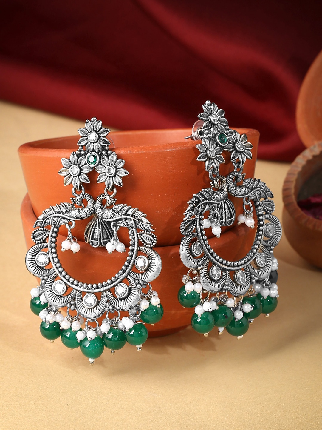 

Yellow Chimes Silver-Toned & Green Silver-Plated Peacock Shaped Chandbalis Earrings