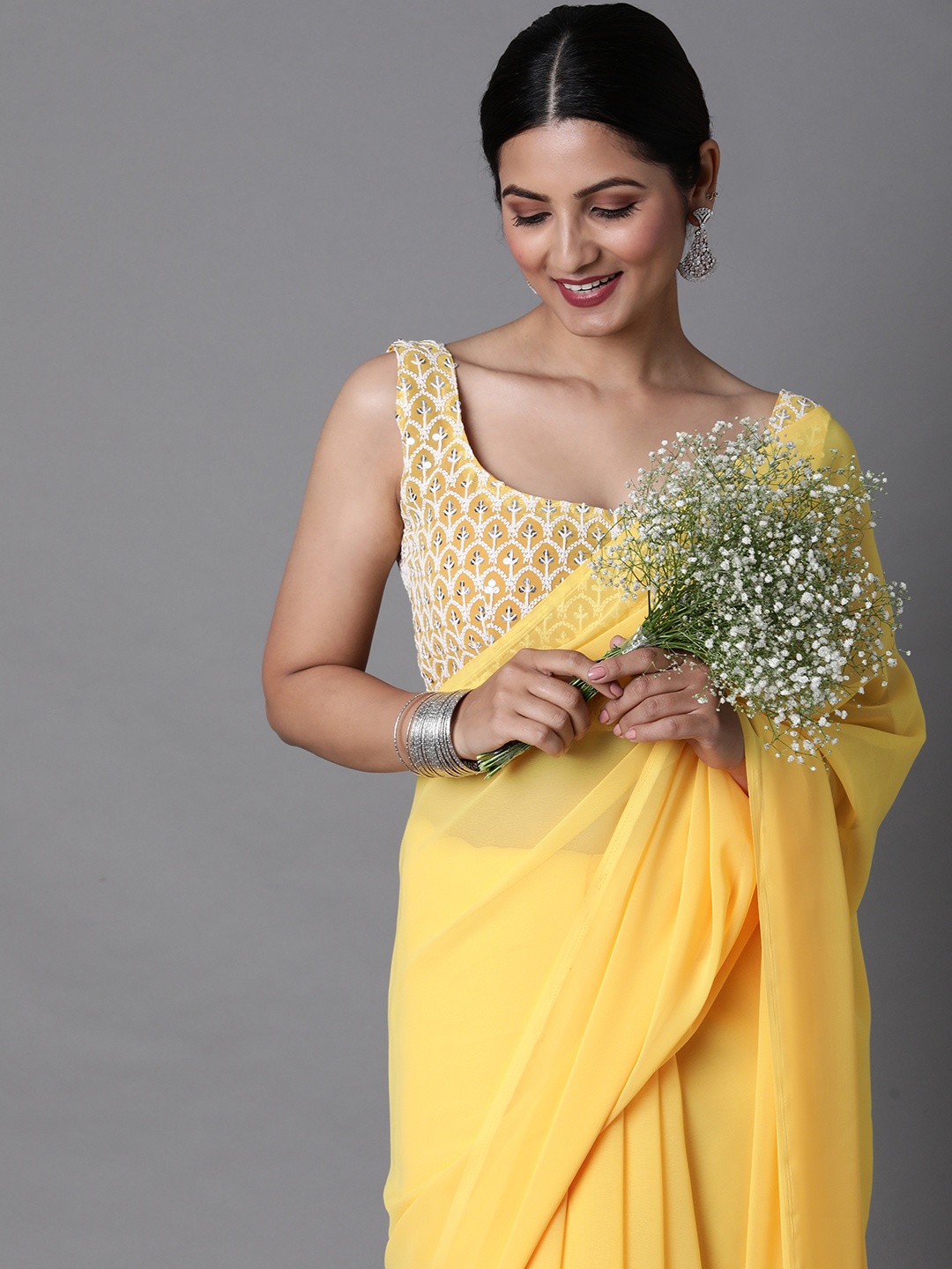 

Mitera Yellow Solid Poly Georgette Saree