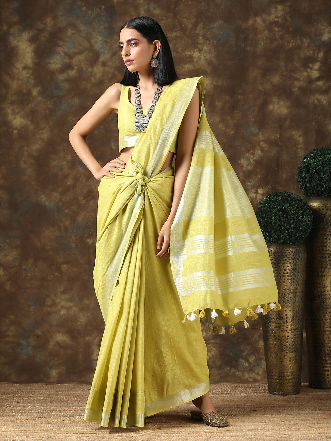 

Triyah Yellow & Silver-Toned Zari Pure Linen Saree