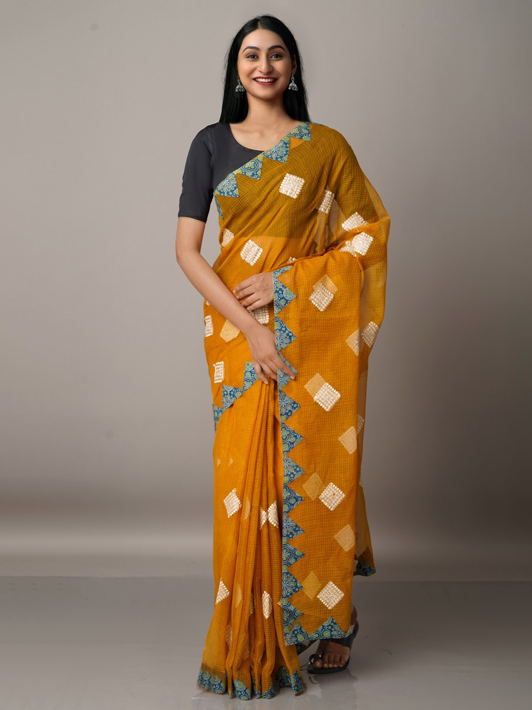 

Unnati Silks Mustard & Blue Ethnic Motifs Patchwork Supernet Patola Saree