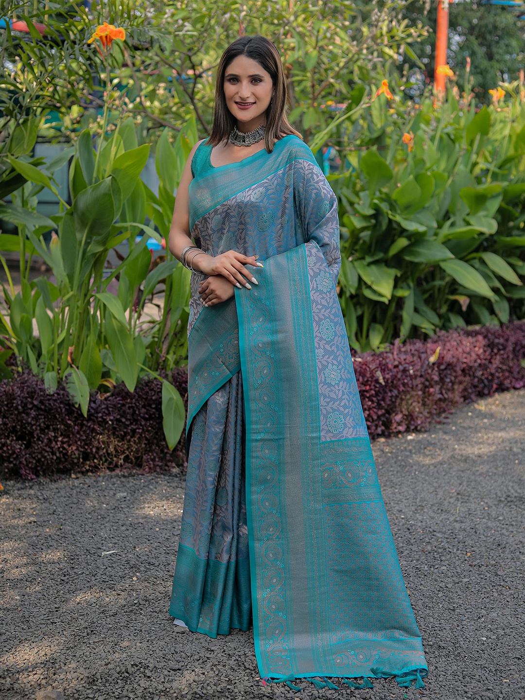 

Mitera Turquoise Blue & Purple Floral Zari Silk Blend Kanjeevaram Saree