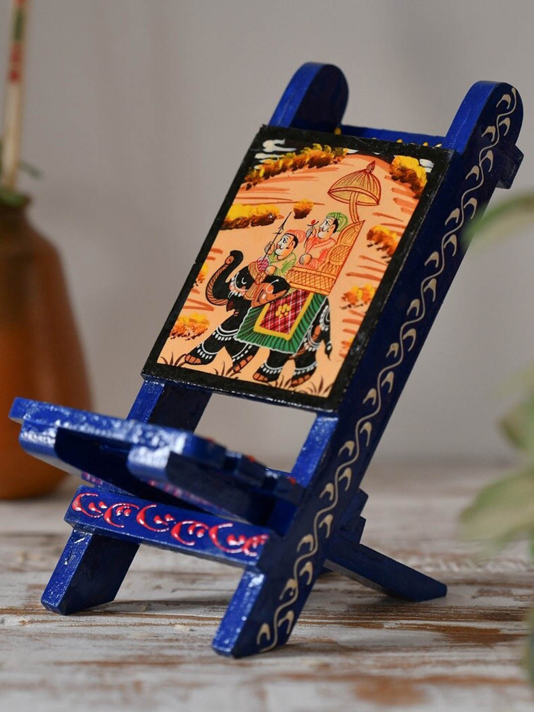 

Fashion Bizz Blue & Orange Mobile Holder Showpiece